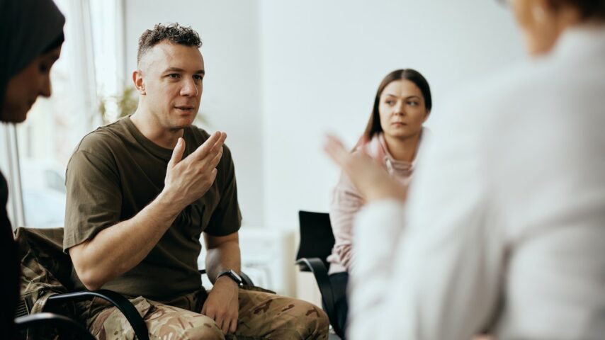Mid adult veteran shares his story with attenders of group therapy at New Jersey healthcare center
