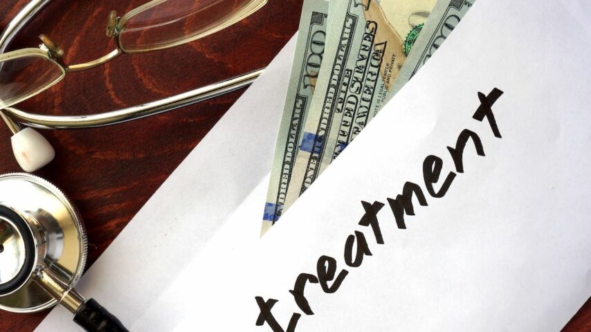 Treatment written on an envelope with dollars
