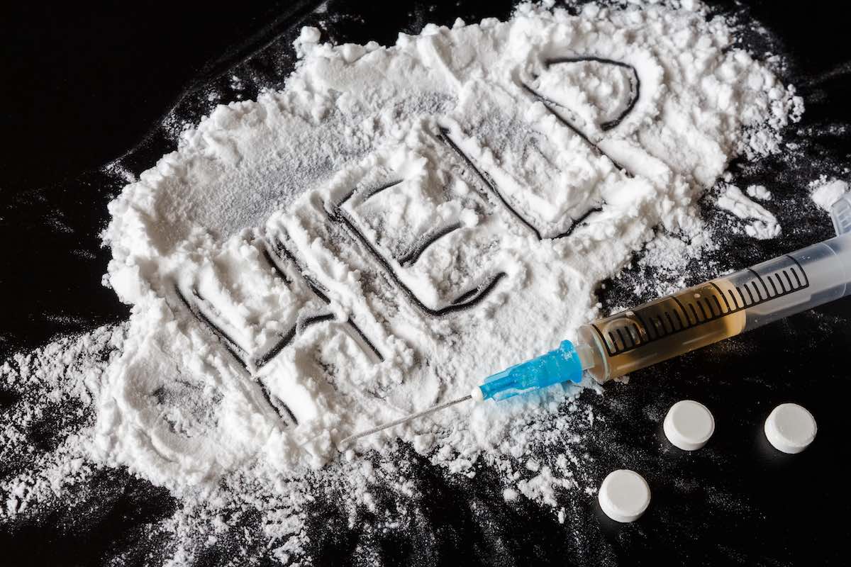 Drug heroin, syringes, money on a dark background with the inscription help