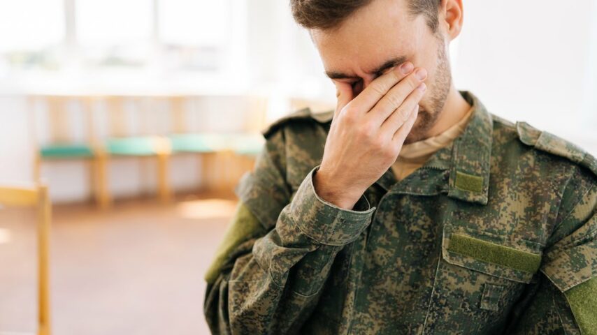 Close-up headshot of frustrated emotional young veteran male in Kentucky rehab center