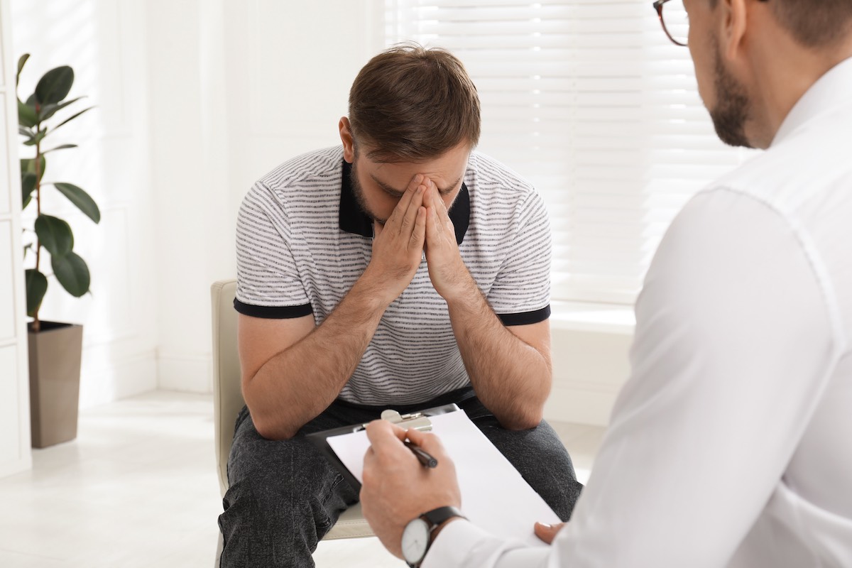 Psychotherapist working with prescription drug addicted young man