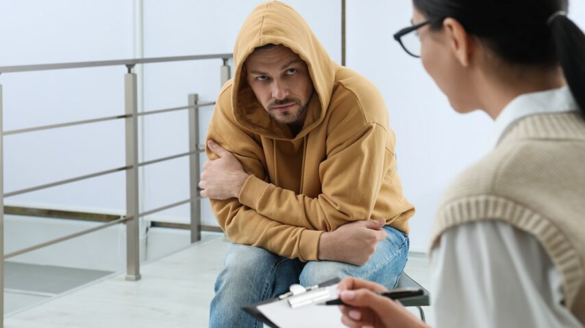 Psychotherapist working with drug addicted man in Utah rehab center