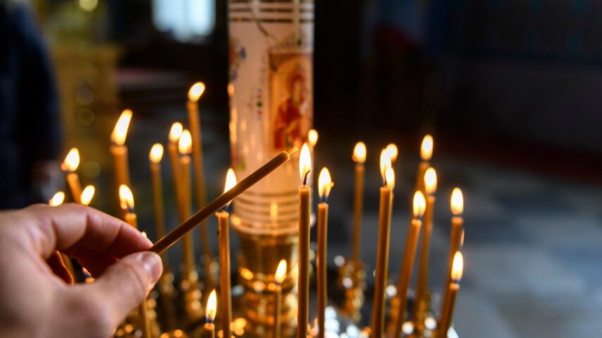 Candles in an orthodox cathedral with icons on background