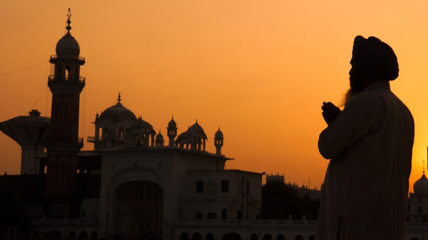 silhouette of sikh pilgrim praying at the holy temple for his addiction recovery journey