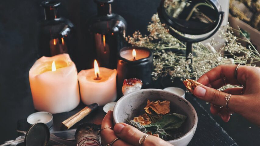 Female Wiccan believer preparing ingredients for a spell at her altar for addiction recovery