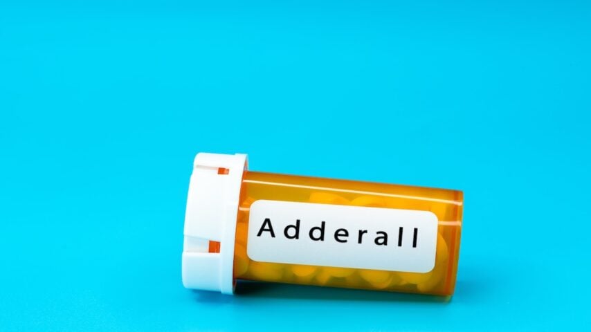 Adderall medical vial with pills in orange plastic container