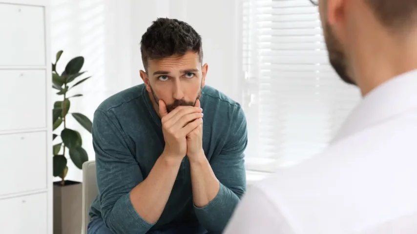 a doctor in a rehab center accessing the male patient being addicted to or misusing guanfacine